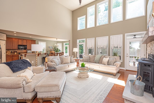 living room with light wood-type flooring and a wood stove