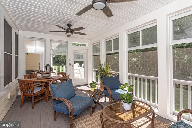 sunroom / solarium with a ceiling fan