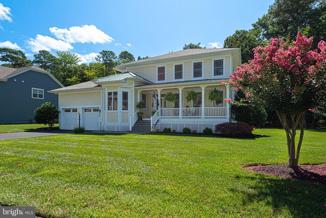 view of front of house featuring a front yard and a garage