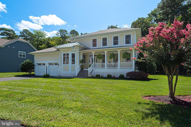 view of front of home featuring an attached garage, a porch, a front yard, and aphalt driveway