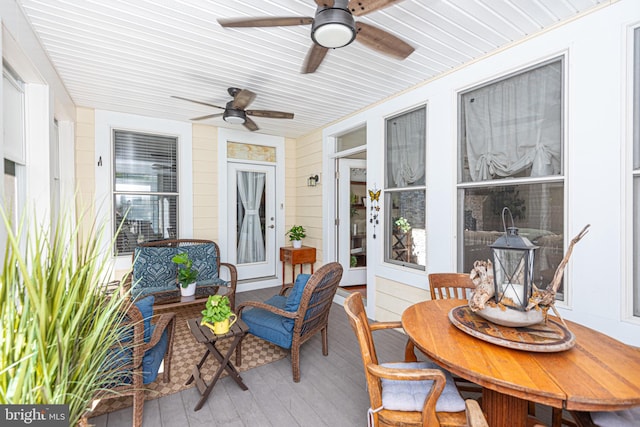 sunroom / solarium featuring ceiling fan