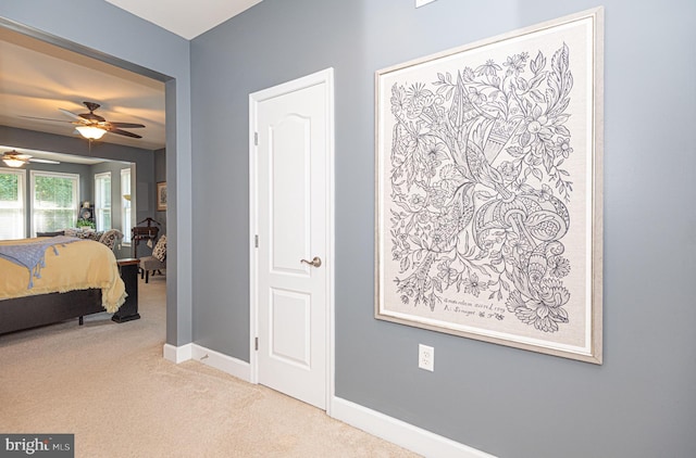 bedroom with baseboards and light colored carpet