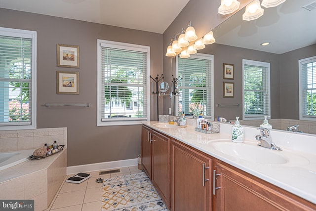 full bath featuring double vanity, a wealth of natural light, tile patterned flooring, and a sink