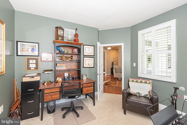 carpeted office with french doors and baseboards