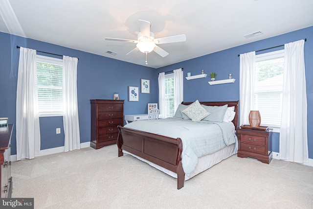 bedroom with light carpet, baseboards, and visible vents