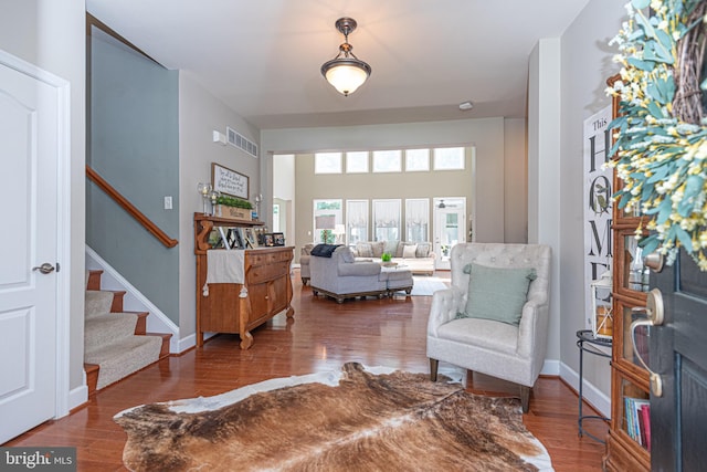 interior space featuring stairs, baseboards, and wood finished floors