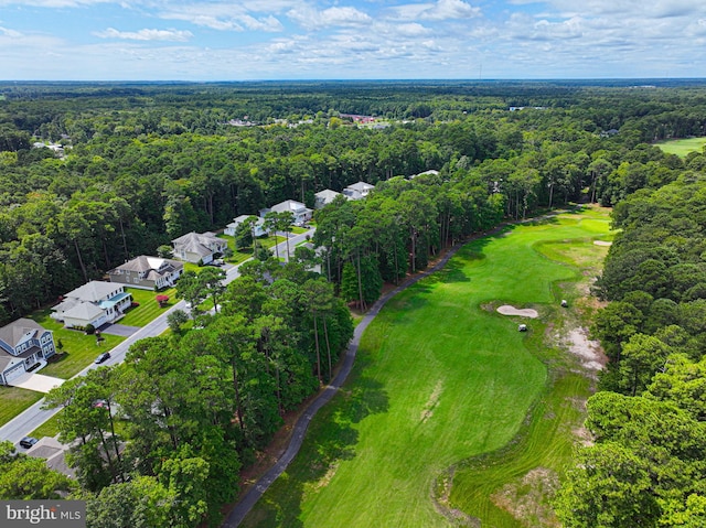 bird's eye view featuring a residential view, view of golf course, and a wooded view