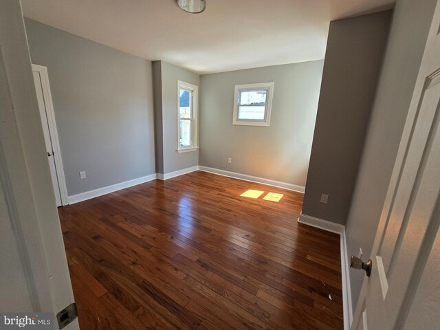 spare room featuring dark wood-type flooring