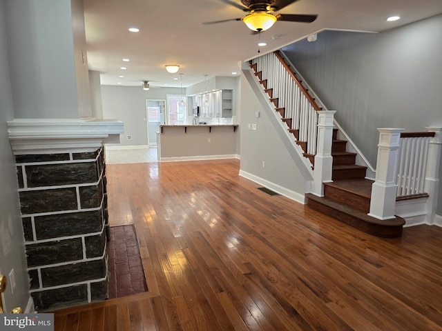 unfurnished living room with ceiling fan and hardwood / wood-style flooring