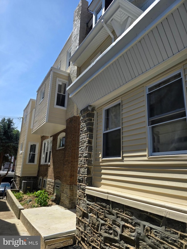 view of side of property with central air condition unit