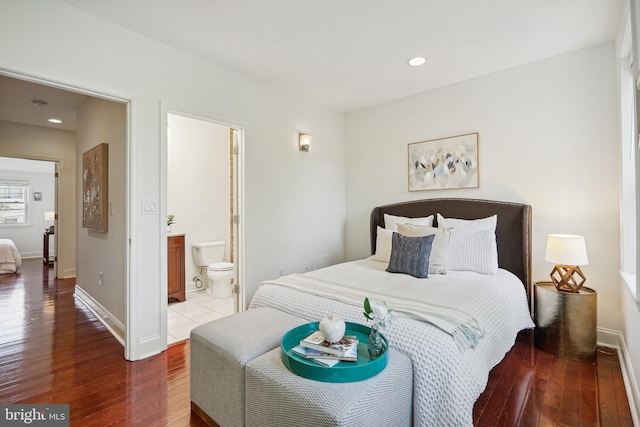 bedroom featuring connected bathroom and light wood-type flooring