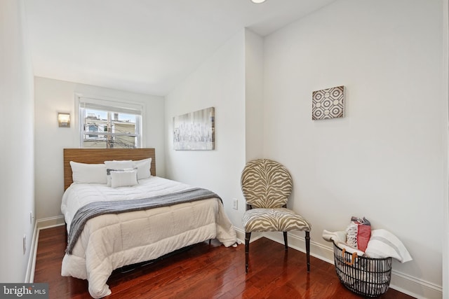 bedroom with lofted ceiling and hardwood / wood-style flooring