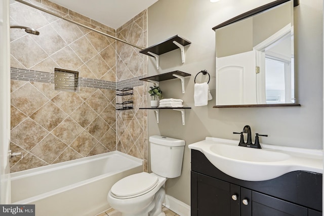 full bathroom with vanity, tiled shower / bath, and toilet