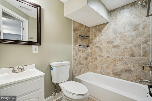 full bathroom featuring tiled shower / bath, vanity, and toilet