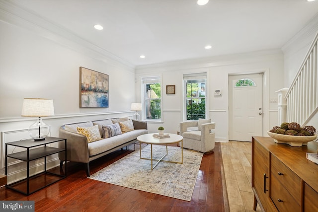 living room with ornamental molding and hardwood / wood-style floors