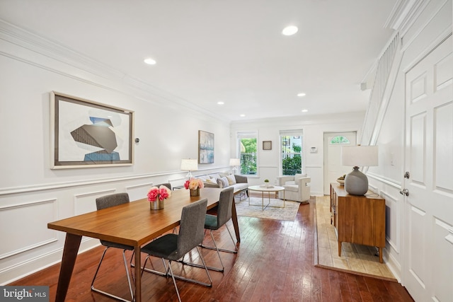 dining space featuring crown molding and hardwood / wood-style floors