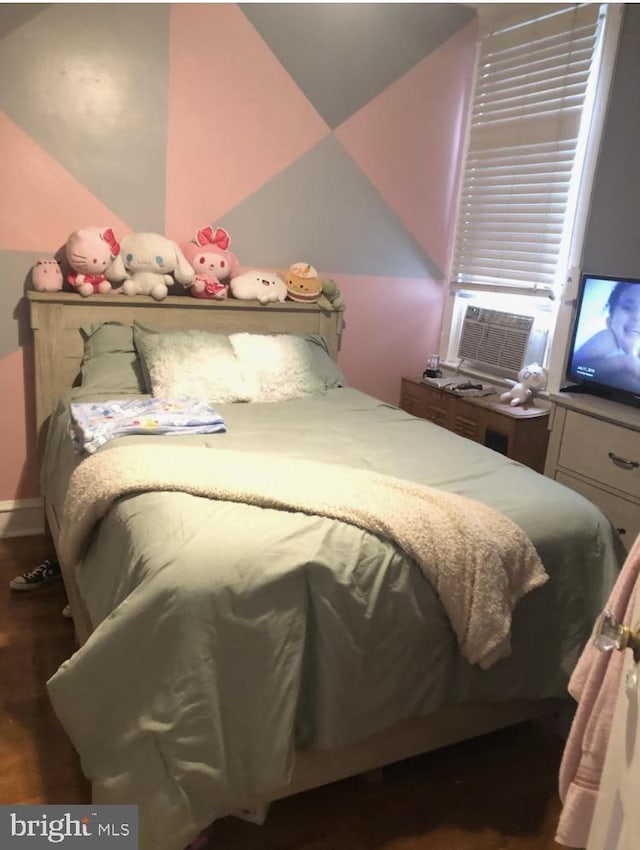 bedroom with cooling unit and dark hardwood / wood-style flooring