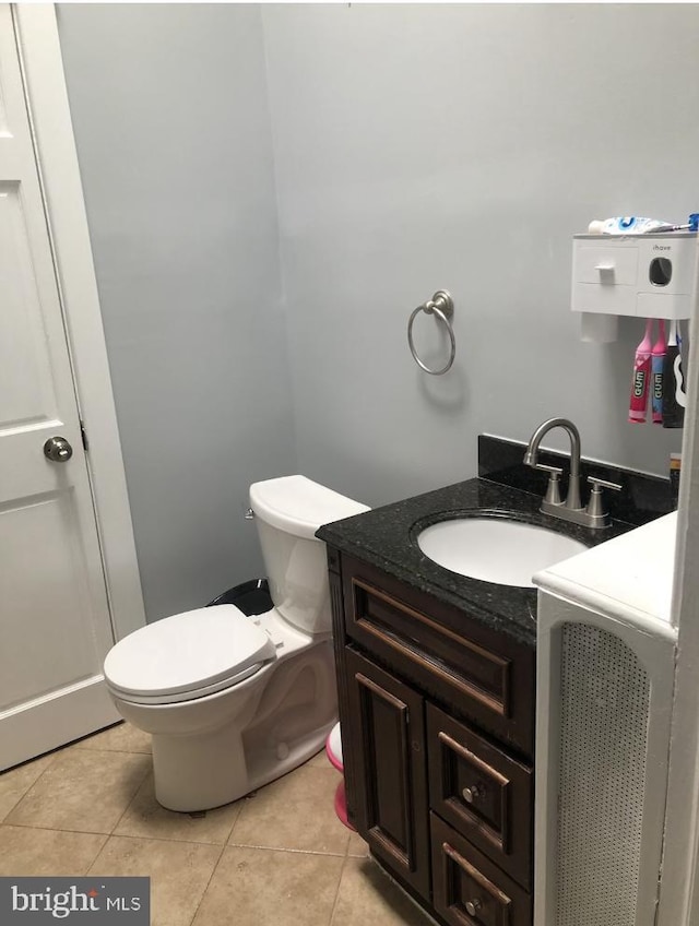 bathroom featuring tile patterned floors, vanity, and toilet