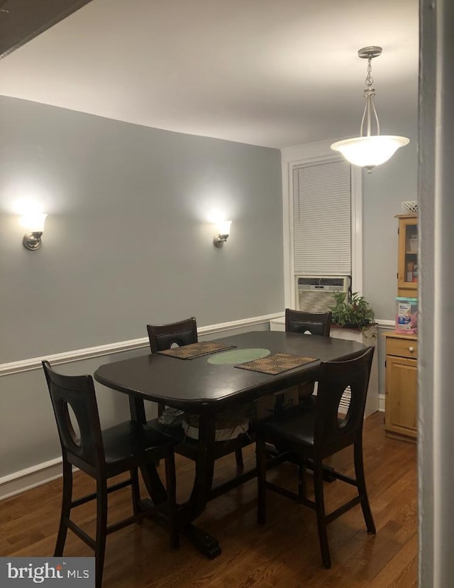 dining room featuring cooling unit and dark hardwood / wood-style flooring