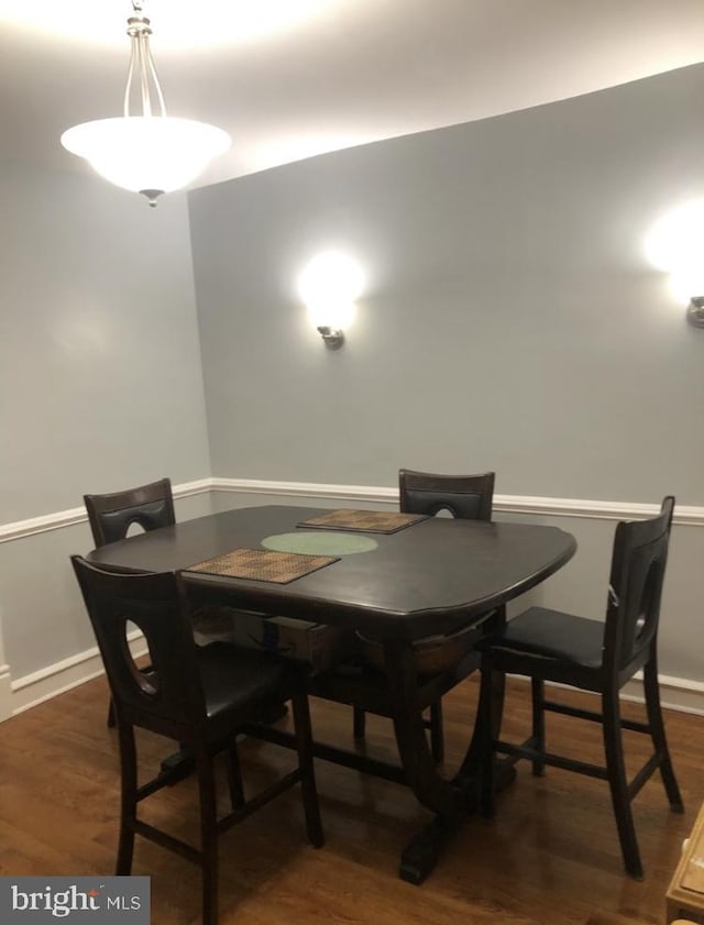 dining area featuring dark wood-type flooring