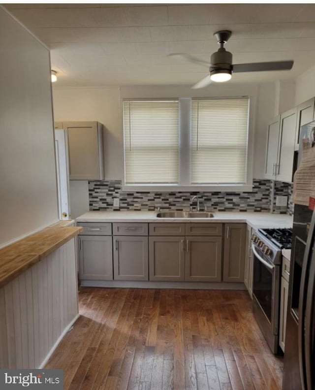 kitchen with tasteful backsplash, stainless steel appliances, dark hardwood / wood-style flooring, and sink