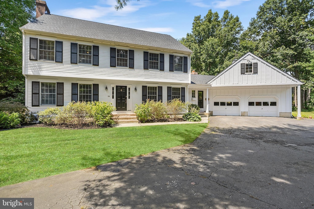 colonial home with a front lawn