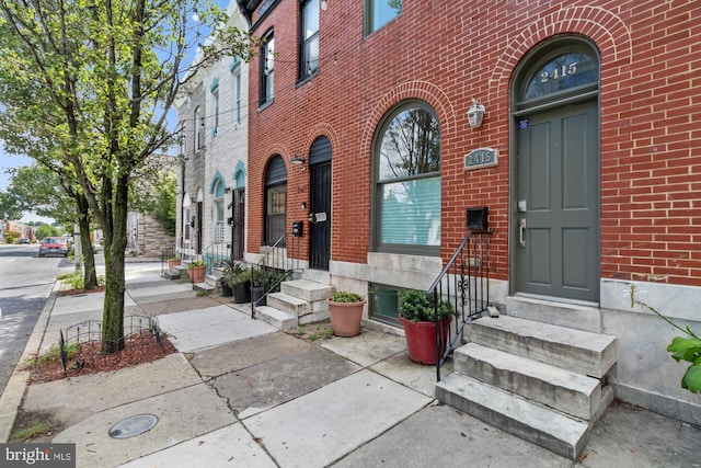 property entrance featuring brick siding