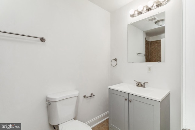 bathroom with vanity, toilet, and tile patterned floors