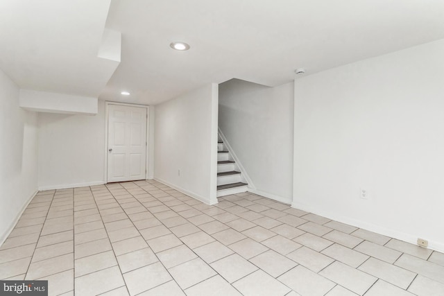 finished basement featuring baseboards, stairway, and recessed lighting
