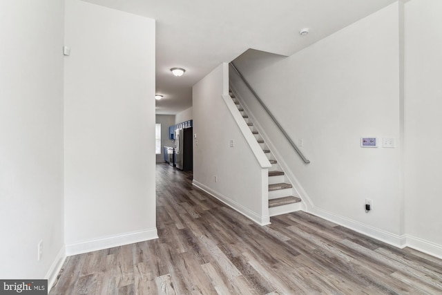 interior space featuring stairway, baseboards, and wood finished floors