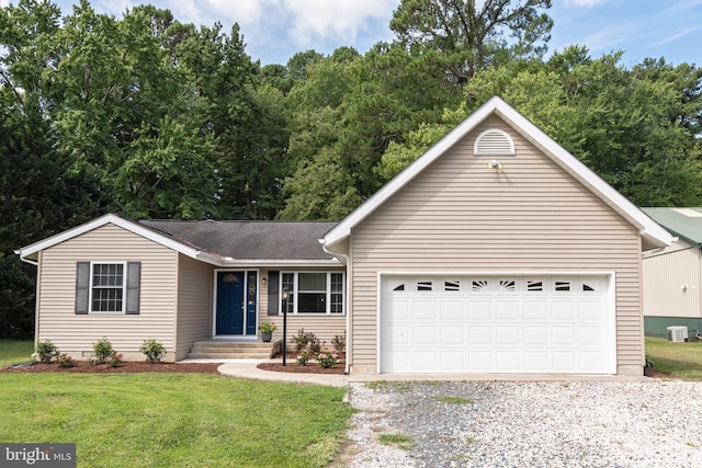 ranch-style house featuring a garage and a front lawn