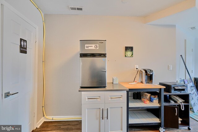 kitchen featuring dark hardwood / wood-style flooring and white cabinetry