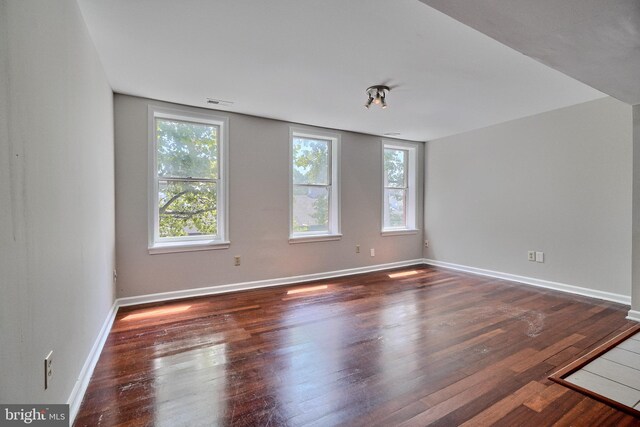 empty room featuring dark hardwood / wood-style flooring