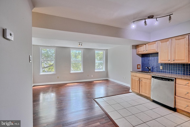 kitchen featuring light brown cabinetry, dishwasher, sink, decorative backsplash, and light hardwood / wood-style flooring