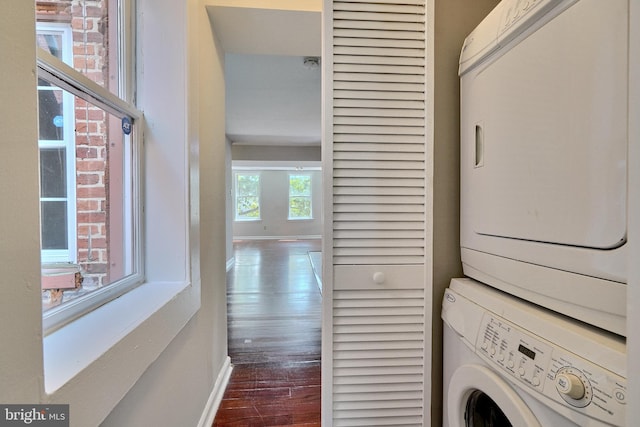 washroom with stacked washer / dryer and hardwood / wood-style floors