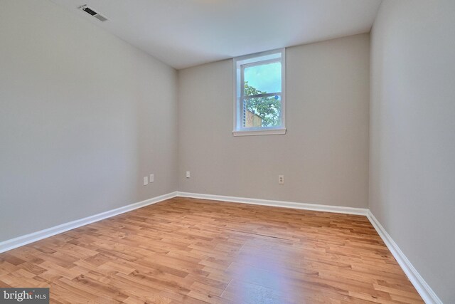 empty room with light hardwood / wood-style flooring