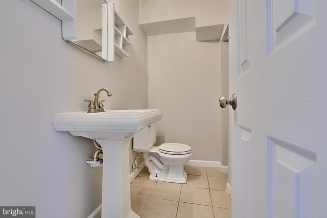 bathroom featuring toilet and tile patterned flooring