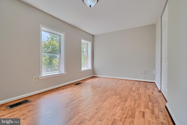 spare room featuring light wood-type flooring