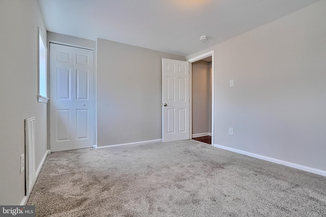 unfurnished bedroom with a closet and carpet flooring