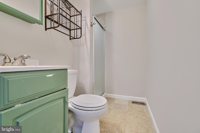 bathroom featuring an enclosed shower, vanity, tile patterned flooring, and toilet