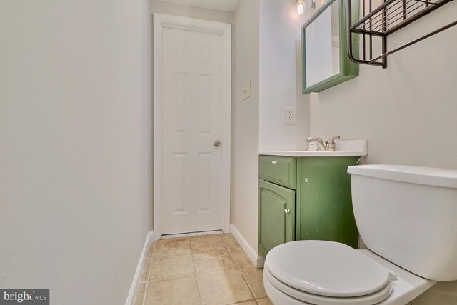 bathroom featuring vanity, tile patterned flooring, and toilet