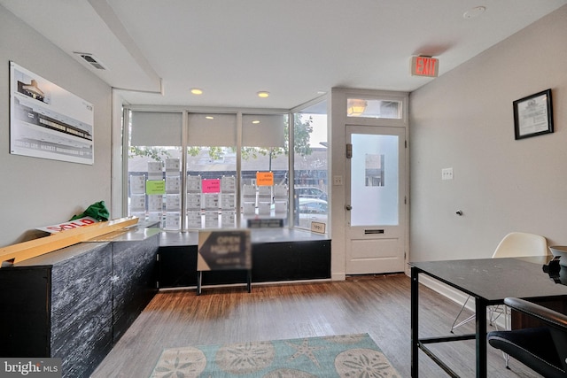 interior space with floor to ceiling windows and wood-type flooring