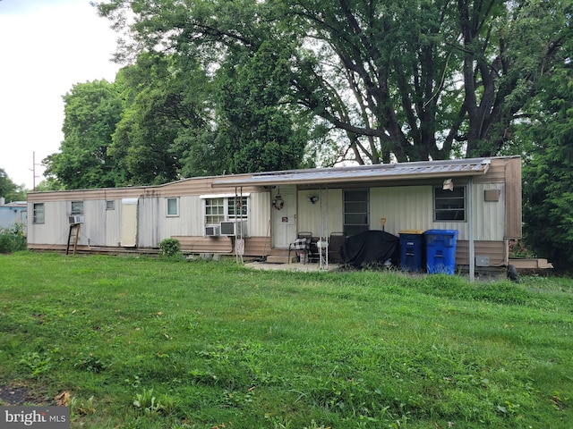 rear view of house featuring a yard