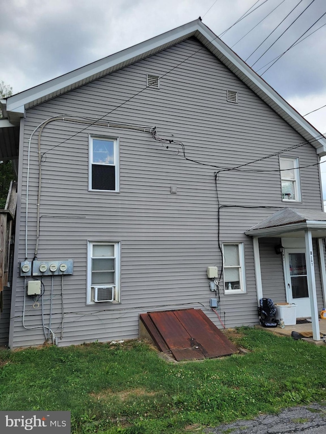 view of property exterior with cooling unit and a yard