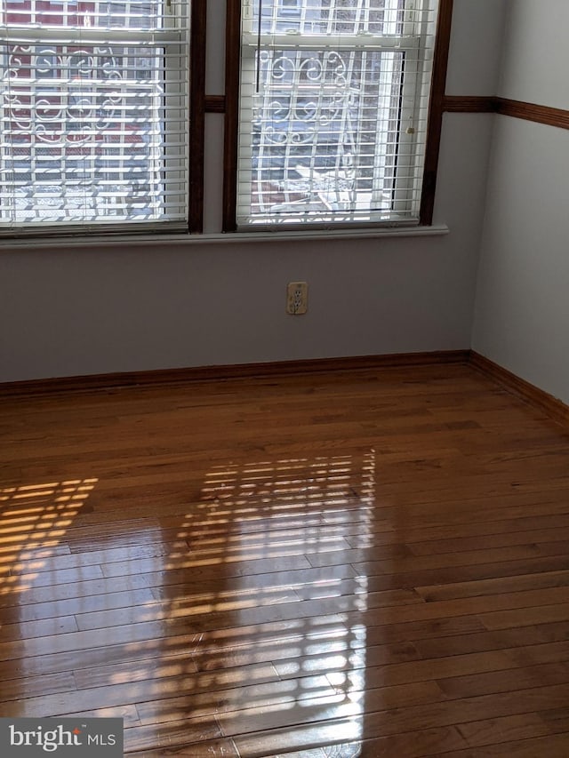 empty room with hardwood / wood-style flooring