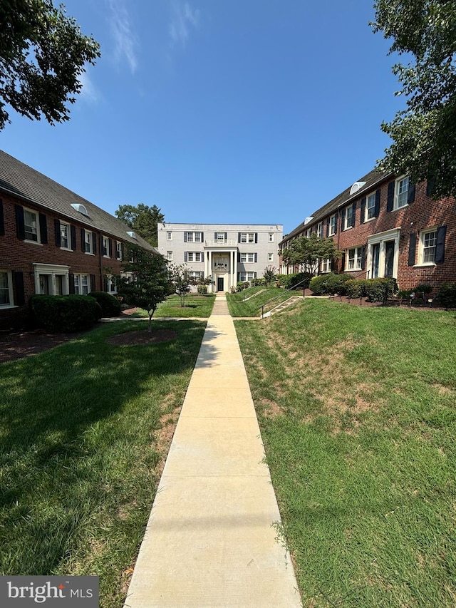 view of property's community featuring a yard