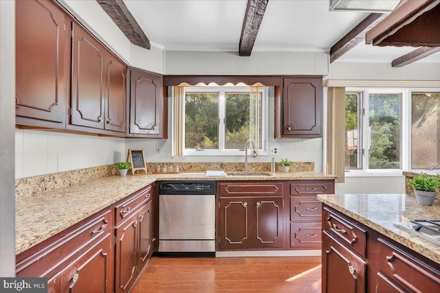 kitchen with dishwasher, sink, beamed ceiling, and plenty of natural light