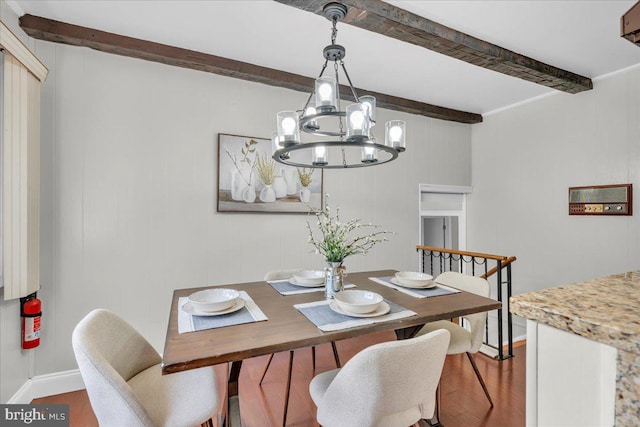 dining room featuring beamed ceiling, hardwood / wood-style floors, and an inviting chandelier