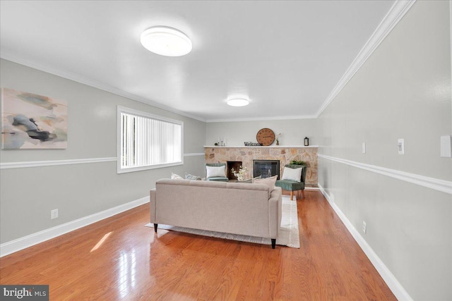 living room with a fireplace, crown molding, and hardwood / wood-style flooring