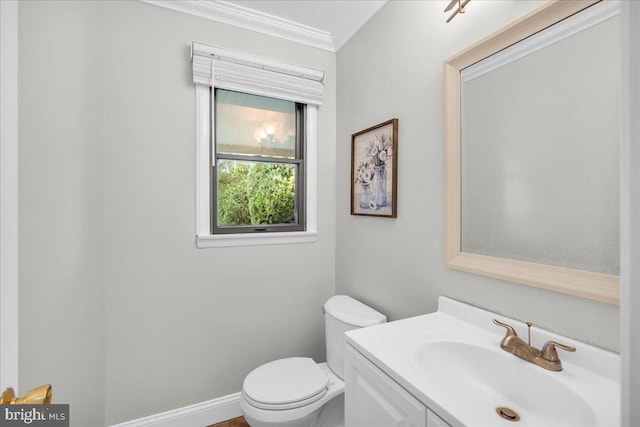 bathroom with crown molding, vanity, and toilet